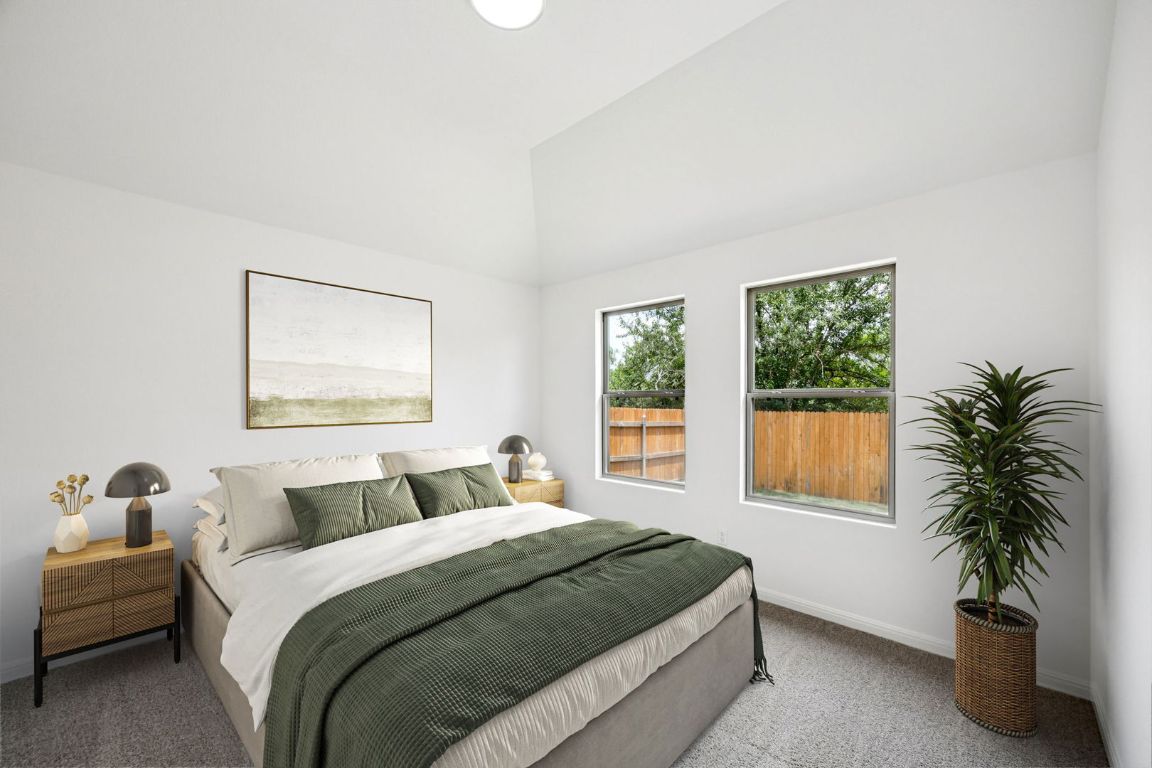 435 Lucky Avenue Elgin, TX 78621 - Photo 13 of 36 a bedroom with a bed and a potted plant