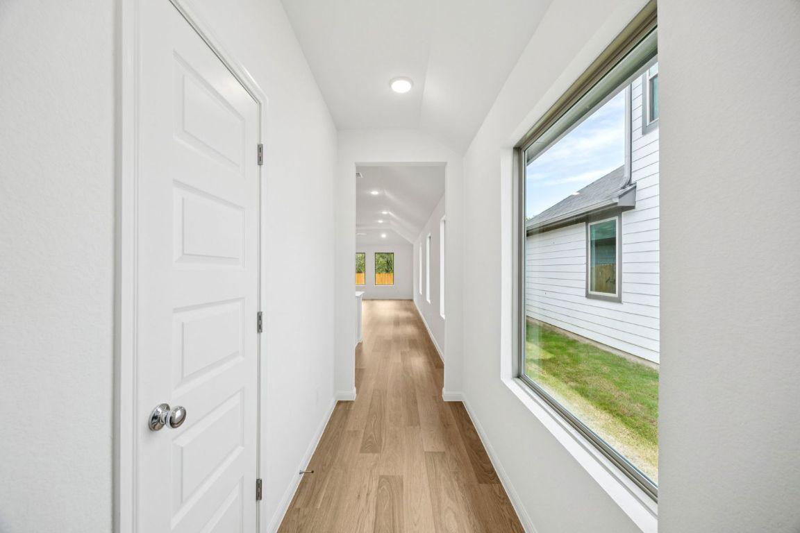 435 Lucky Avenue Elgin, TX 78621 - Photo 26 of 36 a view of a hallway with wooden floor and windows