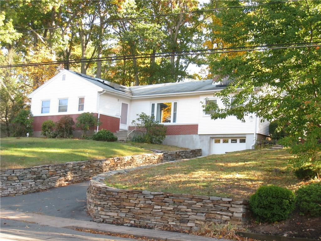 a view of a house with a yard and sitting area