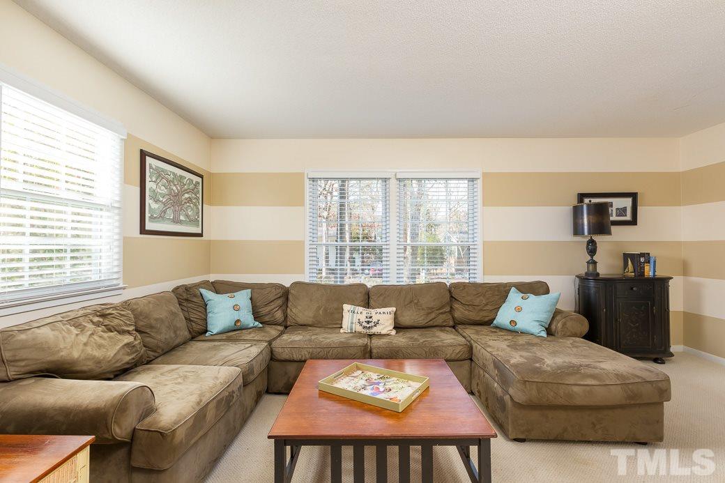 7404 Fiesta Way Raleigh, NC 27615 - Photo 3 of 11 a living room with furniture and a large window