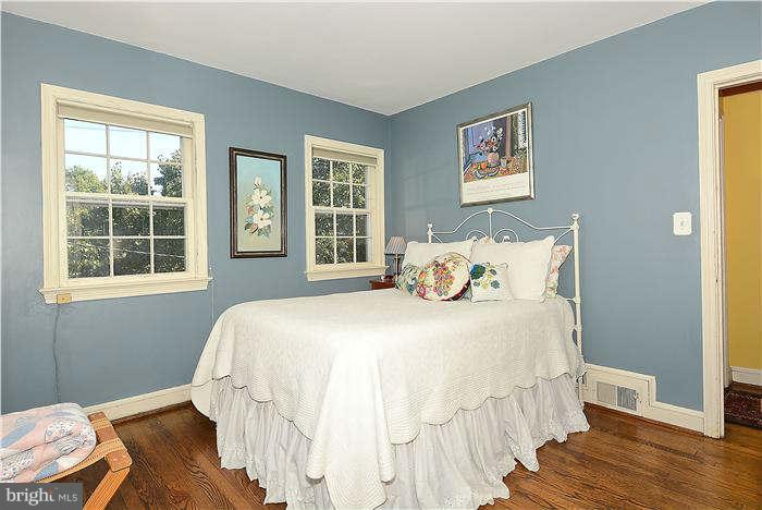 1208 Portner Road Alexandria, VA 22314 - Photo 12 of 30 a bedroom with a bed and wooden floor