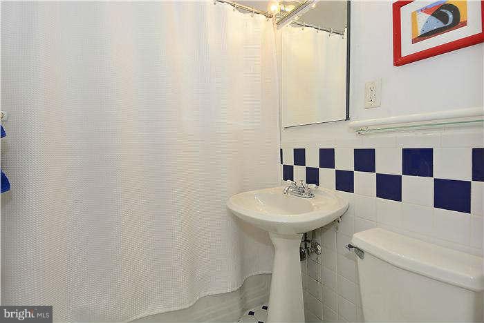 1208 Portner Road Alexandria, VA 22314 - Photo 15 of 30 a bathroom with a sink toilet and shower