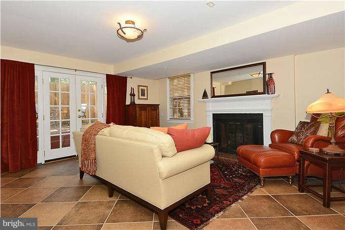 1208 Portner Road Alexandria, VA 22314 - Photo 17 of 30 a living room with furniture a flat screen tv and a fireplace