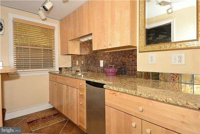1208 Portner Road Alexandria, VA 22314 - Photo 19 of 30 a kitchen with stainless steel appliances granite countertop a sink and a window