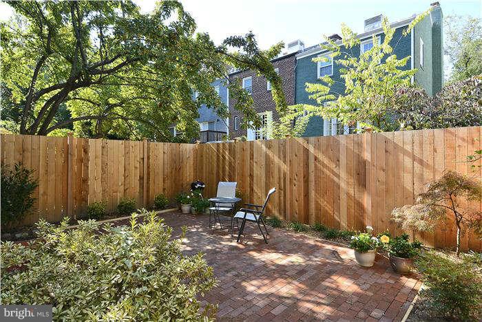 1208 Portner Road Alexandria, VA 22314 - Photo 22 of 30 a backyard of a house with chairs and a tree