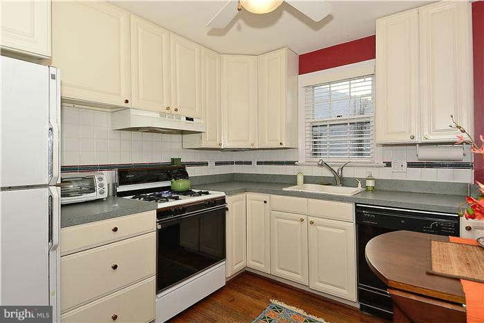 1208 Portner Road Alexandria, VA 22314 - Photo 6 of 30 a kitchen with granite countertop white cabinets and white appliances