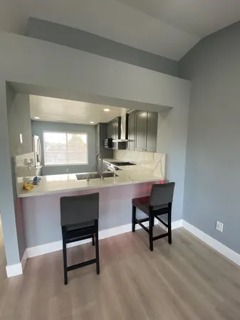 a kitchen with a sink stove and refrigerator