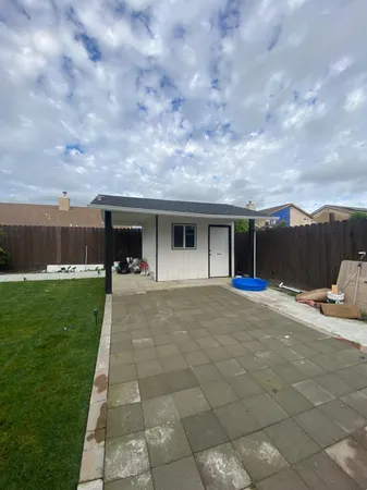 a view of a backyard with sitting area