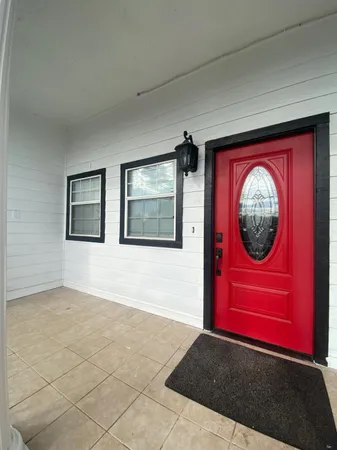 a view of a red door and chair
