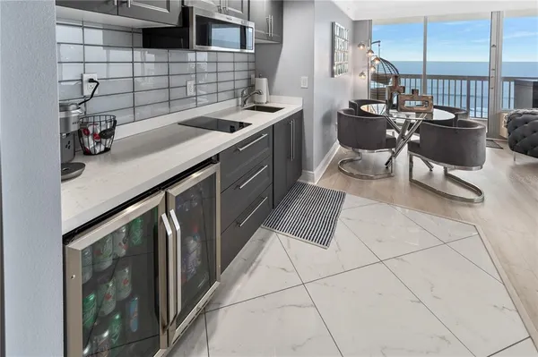 a kitchen with a sink cabinets and stove top oven