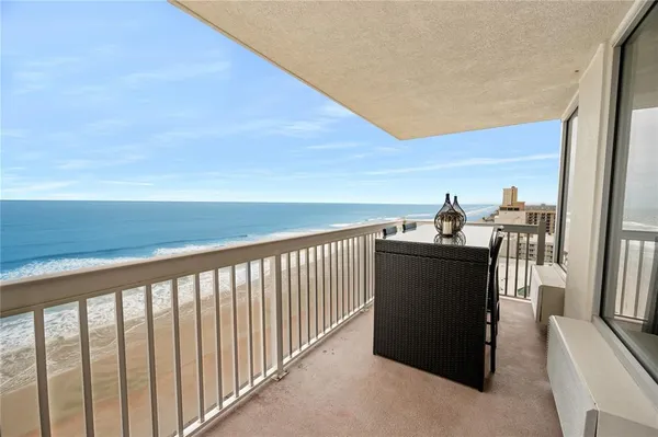 a view of a balcony with furniture