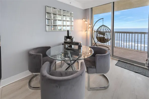 a dining room with furniture and wooden floor