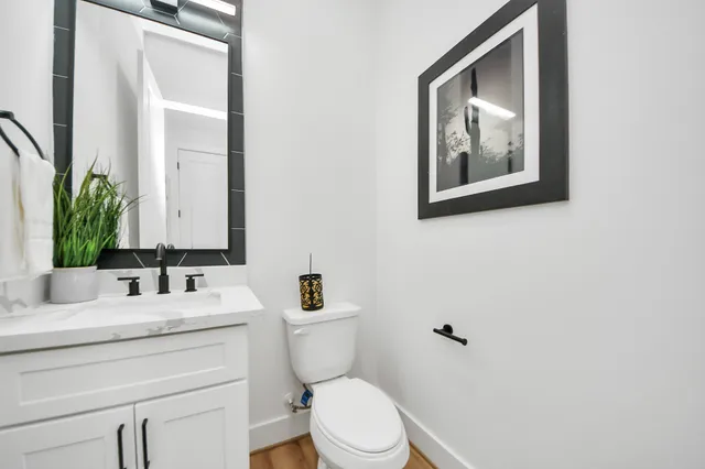 a bathroom with a toilet sink and mirror