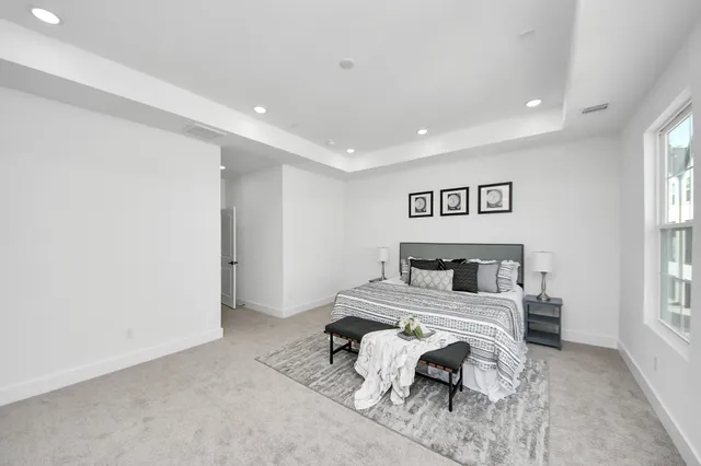 a bedroom with a bed and glass windows