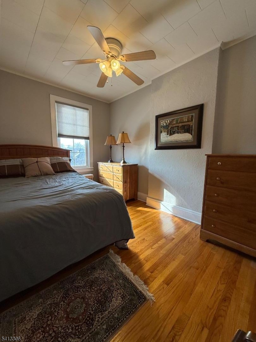 69 2nd Avenue Raritan, NJ 08869 - Photo 9 of 12 a bedroom with a bed lamps and window