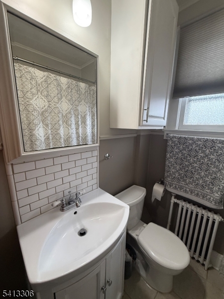 69 2nd Avenue Raritan, NJ 08869 - Photo 10 of 12 a bathroom with a sink a toilet and a mirror