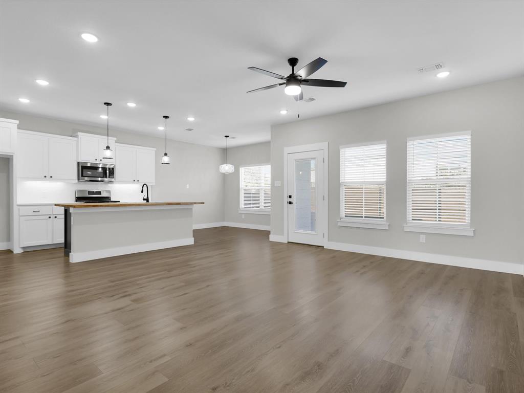 4905 Sweetbay Road Sherman, TX 75092 - Photo 10 of 26 a view of an empty room with wooden floor and a window
