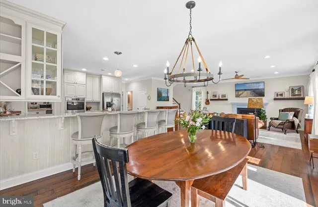 a kitchen with a sink stove cabinets and wooden floor