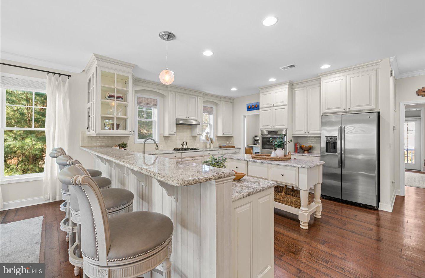 23280 Horse Island Road Lewes, DE 19958 - Photo 14 of 71 a kitchen with stainless steel appliances granite countertop a sink stove and refrigerator