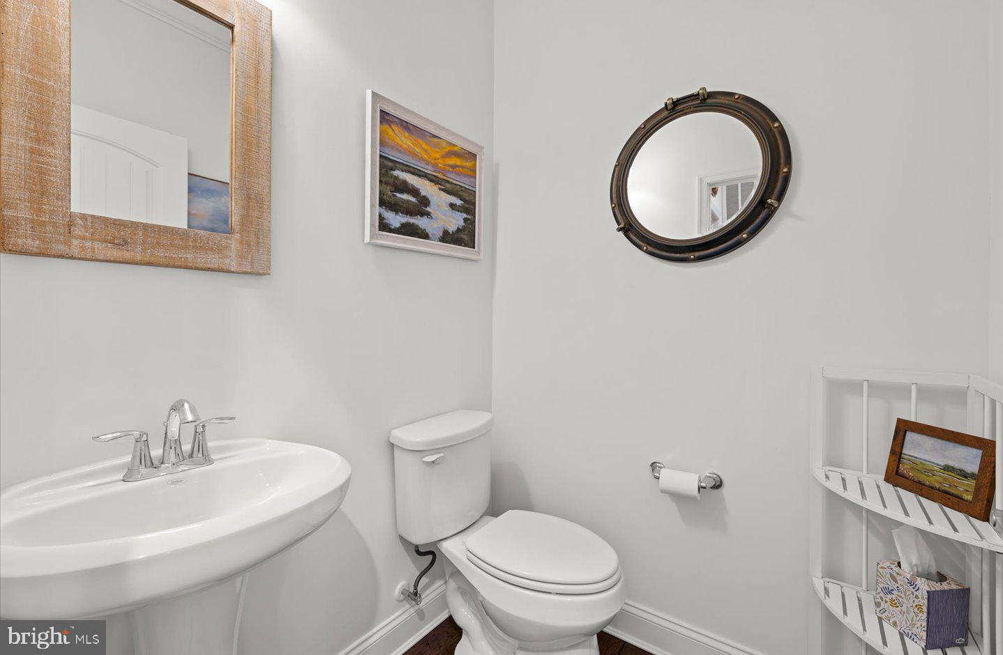 23280 Horse Island Road Lewes, DE 19958 - Photo 20 of 71 a bathroom with a toilet a sink and mirror