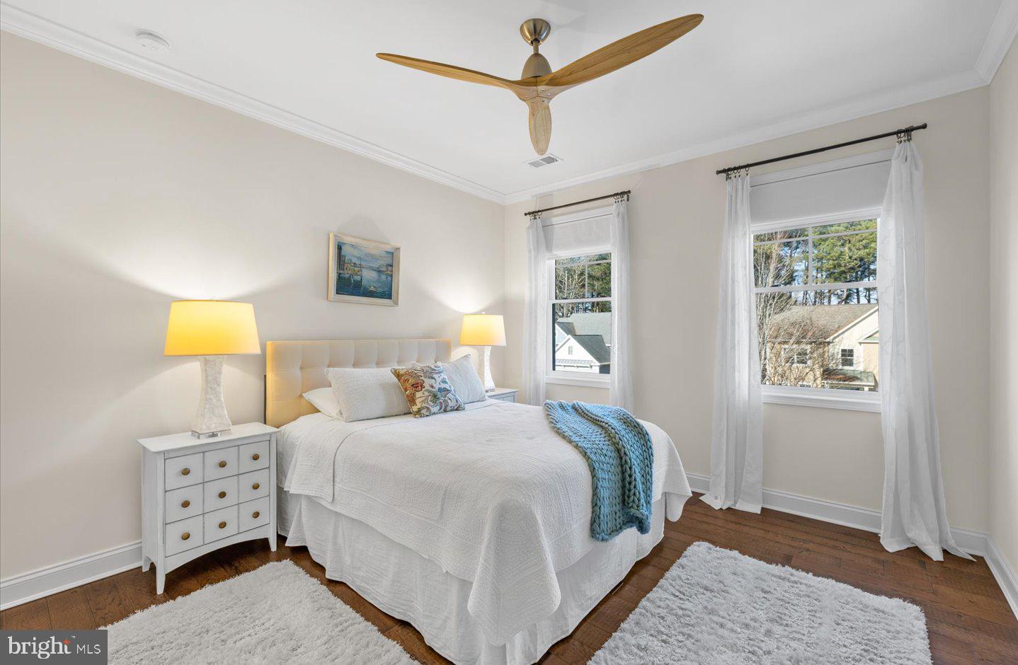 23280 Horse Island Road Lewes, DE 19958 - Photo 31 of 71 a bedroom with a bed a window and a lamp on the dresser