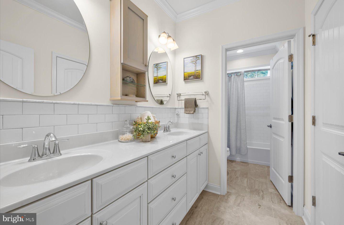 23280 Horse Island Road Lewes, DE 19958 - Photo 34 of 71 a spacious bathroom with a granite countertop sink and a mirror