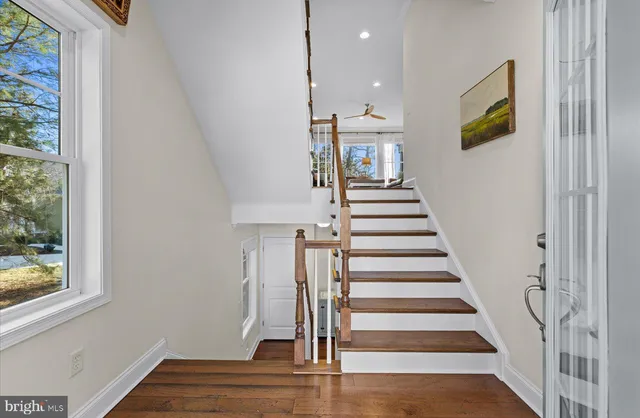 a living room with furniture a fireplace and a large window