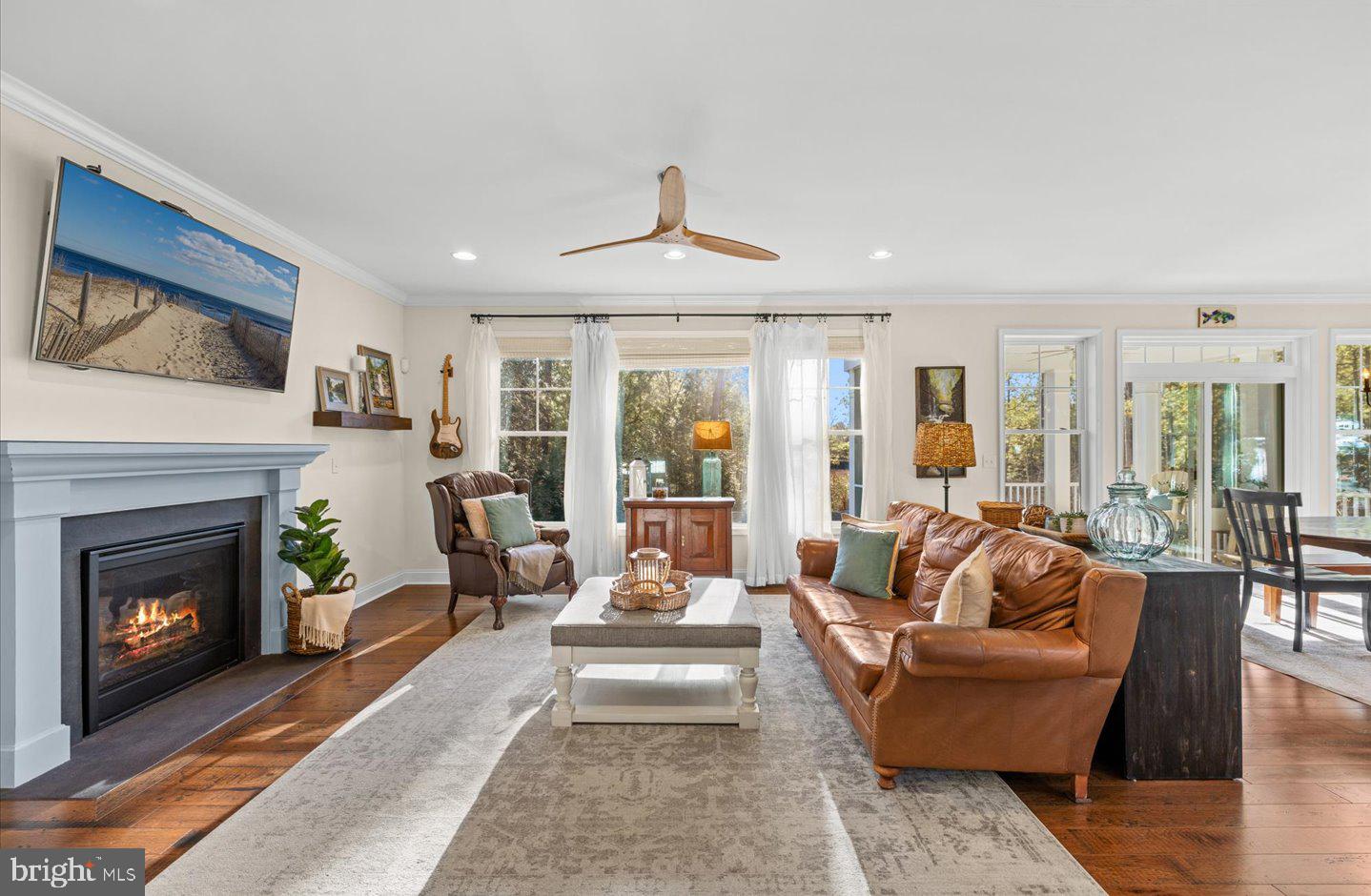 23280 Horse Island Road Lewes, DE 19958 - Photo 6 of 71 a living room with furniture a fireplace and a large window