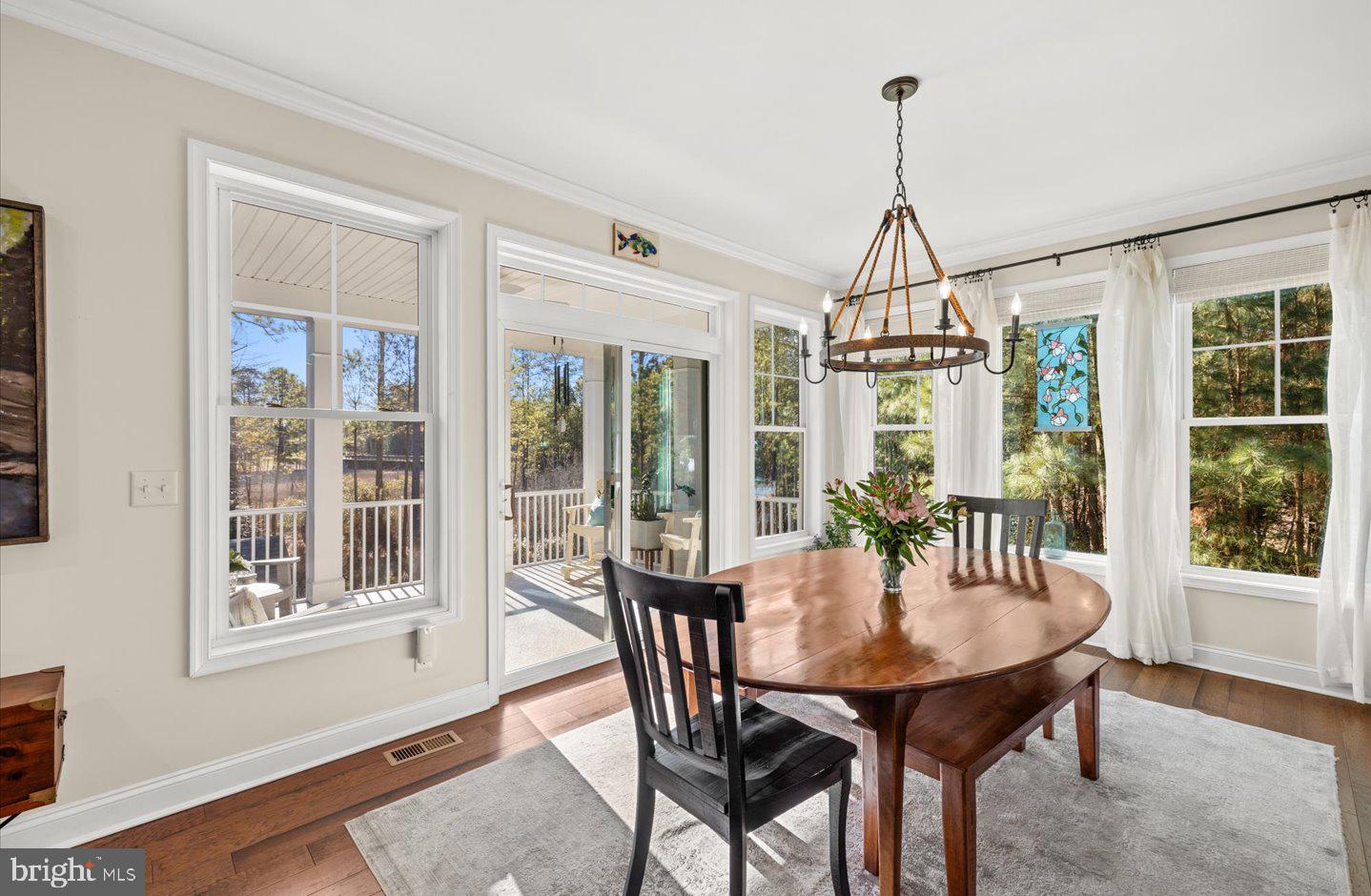 23280 Horse Island Road Lewes, DE 19958 - Photo 9 of 71 a view of a dining room with furniture window and wooden floor
