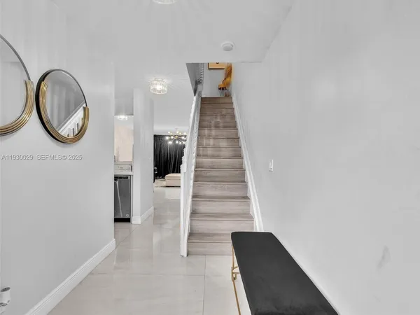 a en suite bathroom with a granite countertop sink and a mirror