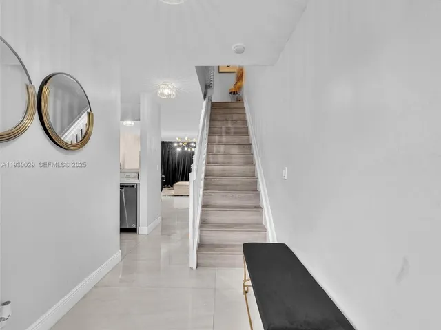 a en suite bathroom with a granite countertop sink and a mirror