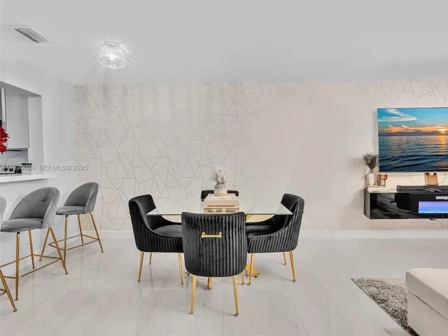 a dining room with furniture and a chandelier