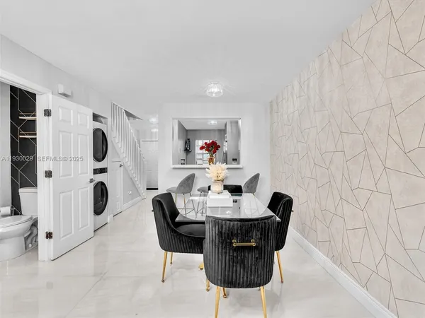 a dining room with furniture and a mirror