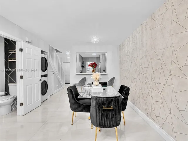 a dining room with furniture and a mirror