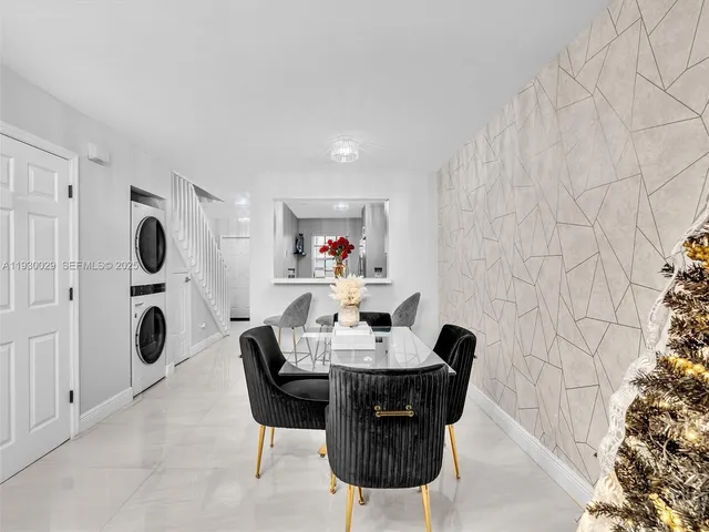 a living room with furniture a rug and a flat screen tv