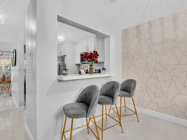 a living room with furniture a rug and a flat screen tv
