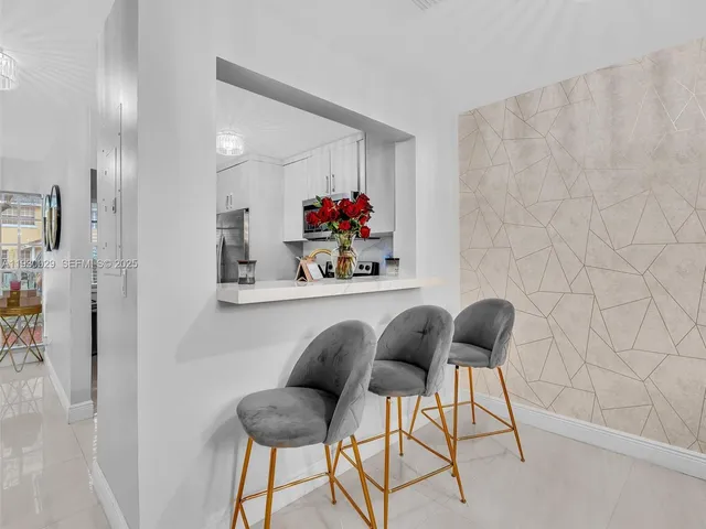 a living room with furniture a rug and a flat screen tv