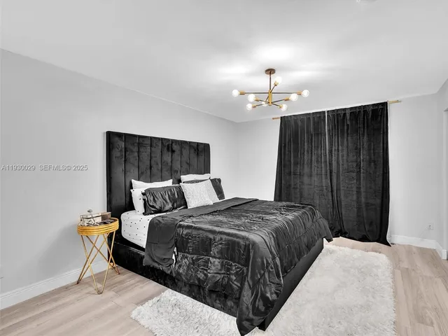 a bedroom with a bed and a ceiling fan