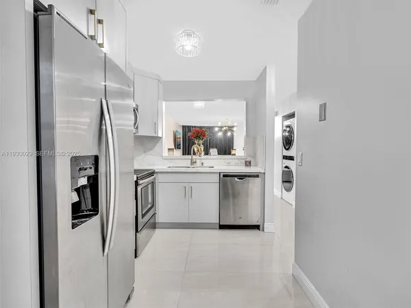 a kitchen with a sink refrigerator and cabinets