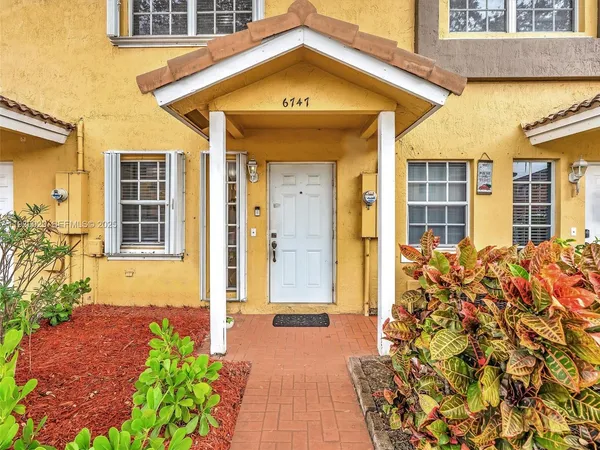an aerial view of a house with a garden