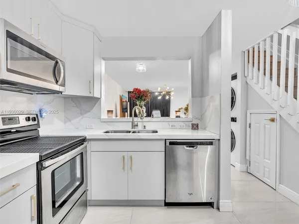 a kitchen with a sink stove and cabinets