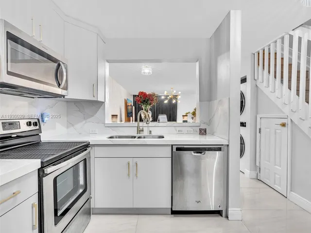 a kitchen with a sink stove and cabinets