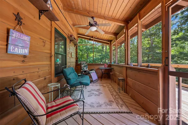 a living room with furniture a wooden floor and a large window