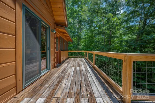 a view of balcony with wooden floor and fence