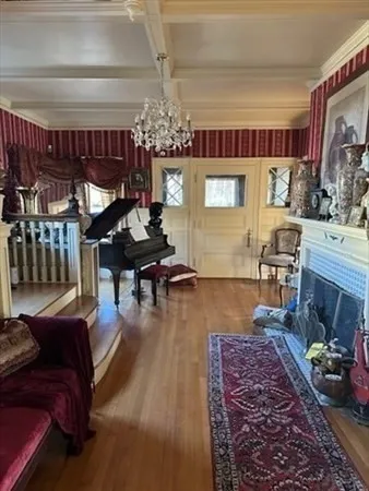 a living room with furniture and a chandelier