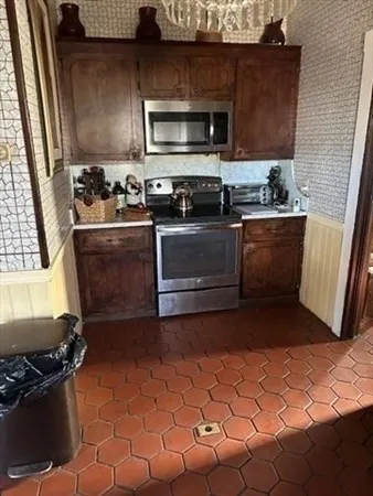 a kitchen with a stove and a microwave