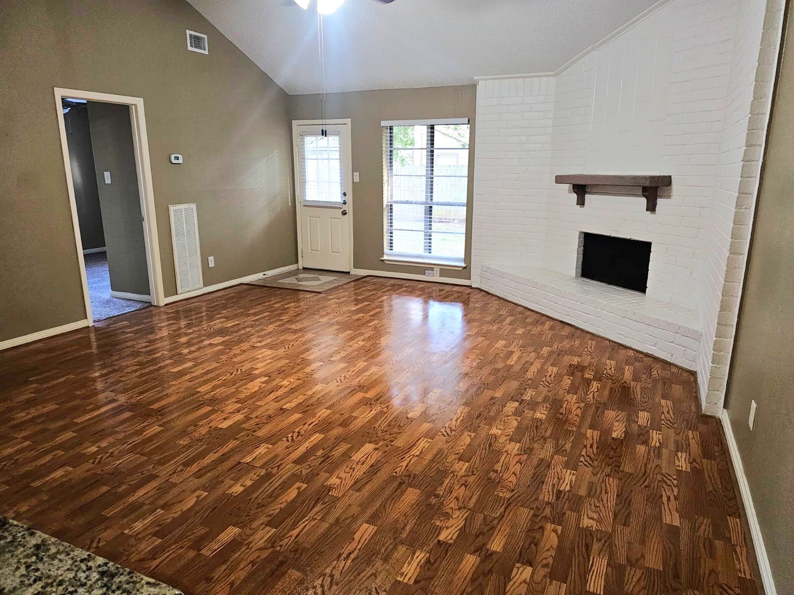2618 Quarry Hill Road Sugar Land, TX 77478 - Photo 9 of 15 wooden floor in an empty room with a fireplace
