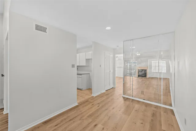 a view of empty room with wooden floor