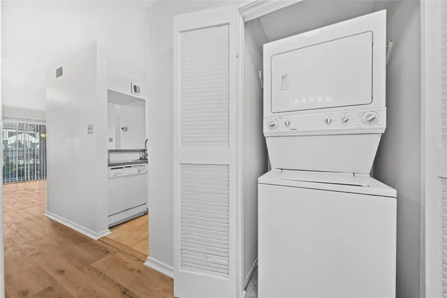a view of washer and dryer with wooden floor