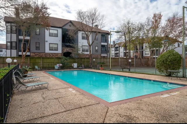 a swimming pool with outdoor seating and yard